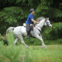 Dr Brianne Henderson riding a grey horse
