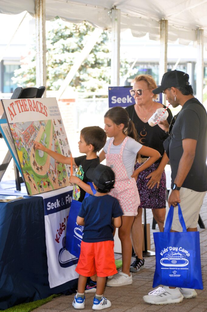 Kids interact with the display at Ontario Racing Kid's Camp